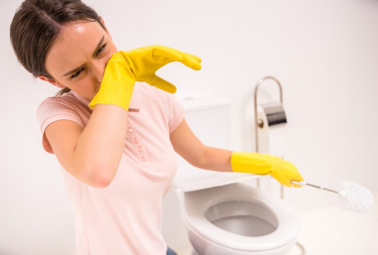 Lady struggling to clean which is why toilet brushes are not used in hotels as they are disgusting